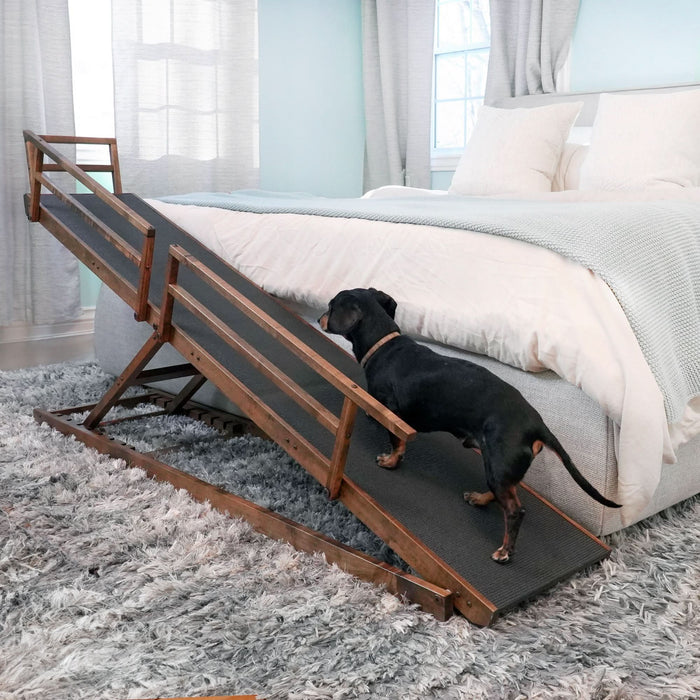 Small dog walking up dog ramp to get on the bed, demonstrating ease of walkway incline